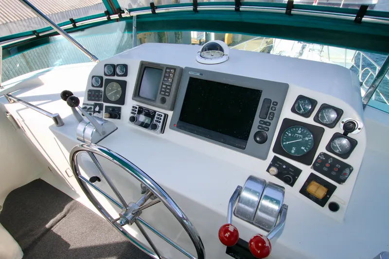  Yacht Photos Pics Control panel of a 1999 McKinna 47 Sedan yacht with navigation instruments.