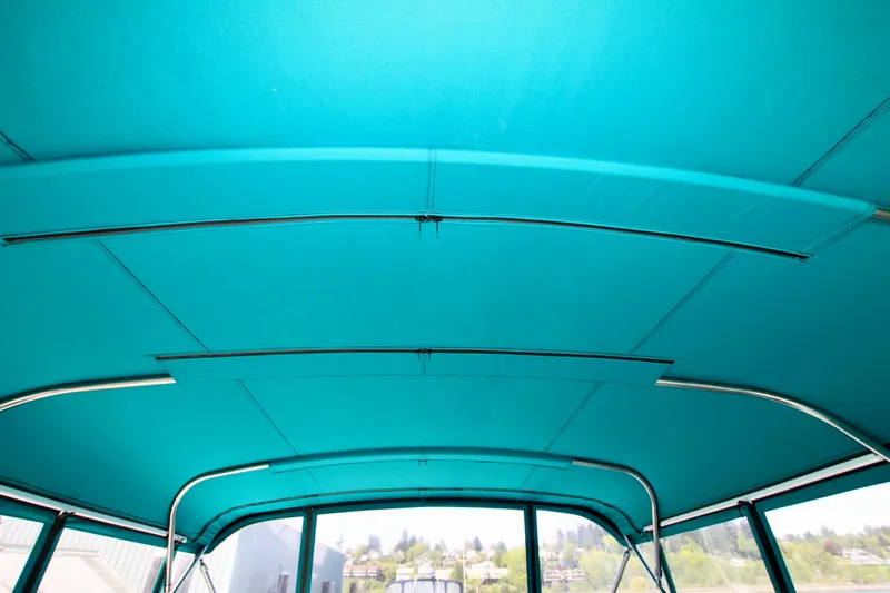  Yacht Photos Pics Interior view of a 1999 McKinna 47 Sedan boat with teal canopy.