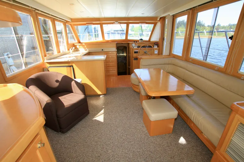  Yacht Photos Pics Interior of a 1999 McKinna 47 Sedan yacht with seating and dining area.