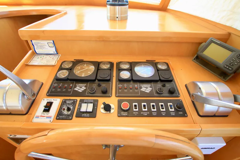  Yacht Photos Pics Control panel of a 1999 McKinna 47 Sedan yacht with gauges and navigation equipment.