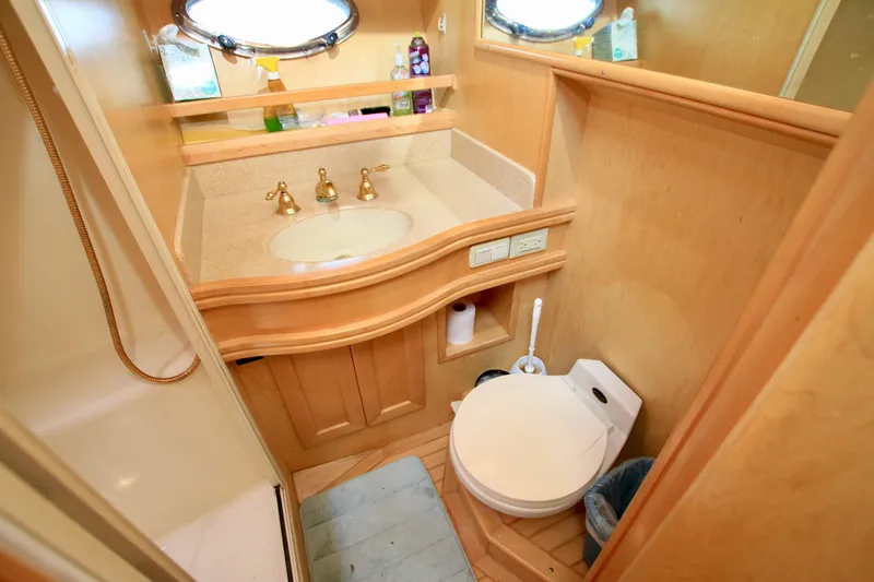  Yacht Photos Pics Bathroom interior of 1999 McKinna 47 Sedan yacht with sink and toilet.