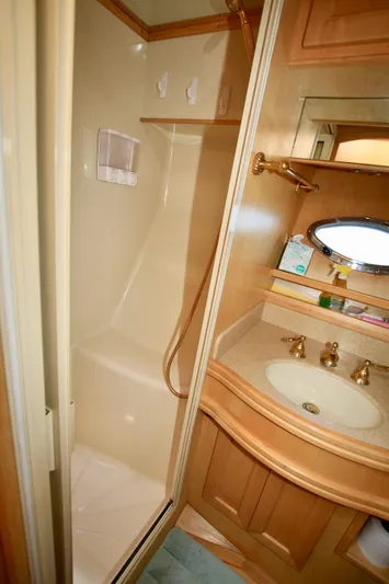  Yacht Photos Pics Bathroom interior of a 1999 McKinna 47 Sedan yacht with shower and sink.