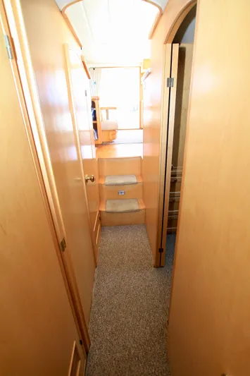  Yacht Photos Pics Interior hallway of a 1999 McKinna 47 Sedan yacht with wooden finishes.