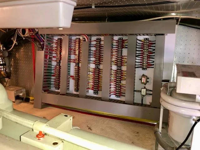  Yacht Photos Pics Electrical panel inside a 1999 McKinna 47 Sedan yacht, showcasing wiring and components.