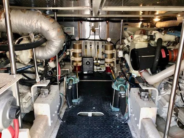  Yacht Photos Pics Engine room of a 1999 McKinna 47 Sedan yacht, showcasing mechanical components and systems.
