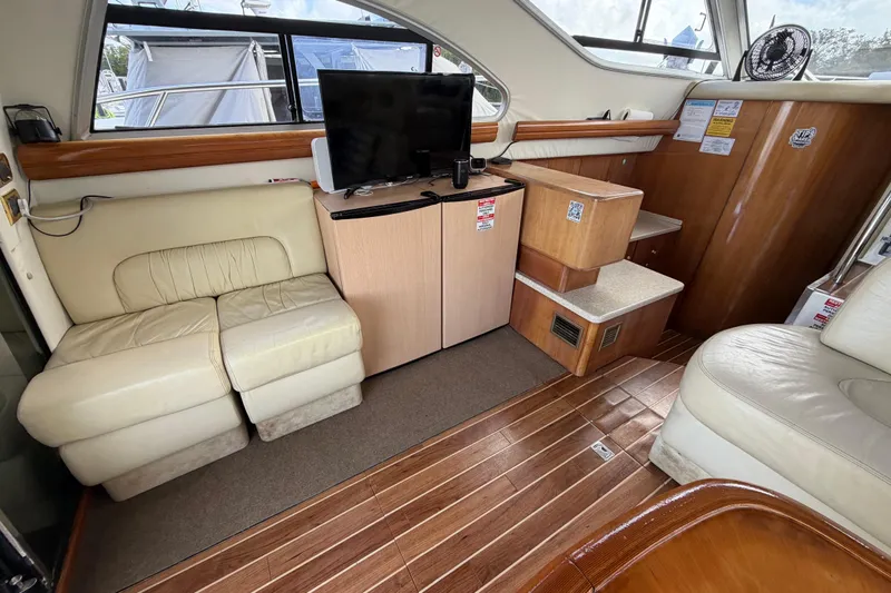  Yacht Photos Pics Interior of 2007 Cranchi Atlantique 40 yacht with seating, TV, and wooden flooring.