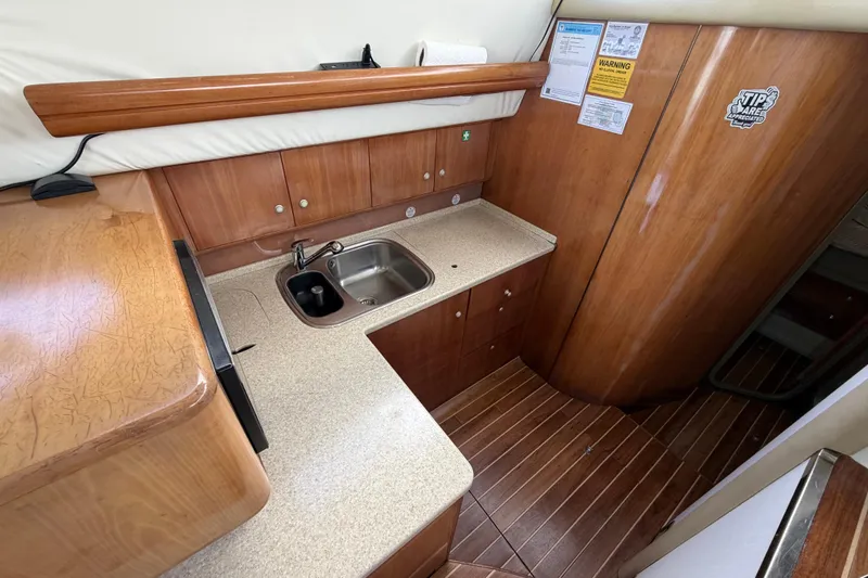  Yacht Photos Pics 2007 Cranchi Atlantique 40 yacht kitchen with wooden cabinetry and stainless steel sink.
