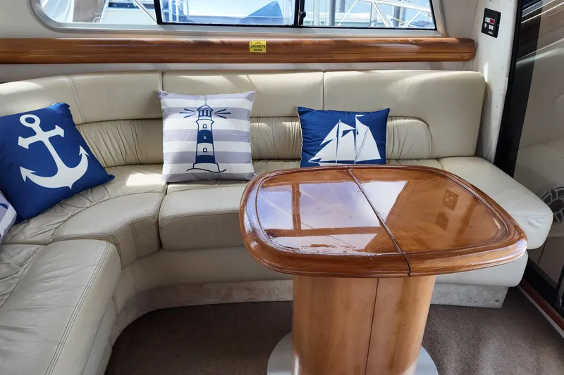  Yacht Photos Pics Luxurious 2007 Cranchi Atlantique 40 yacht interior with nautical-themed cushions and wooden table.