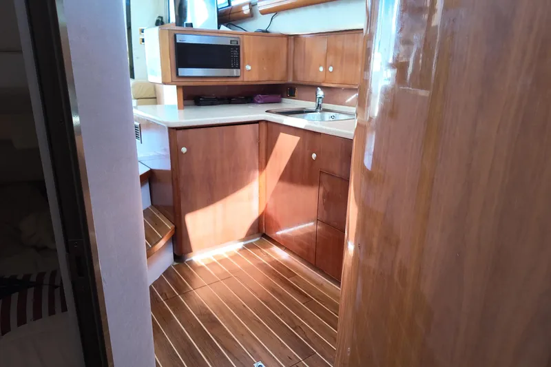  Yacht Photos Pics Interior of 2007 Cranchi Atlantique 40 yacht with wooden cabinetry and modern kitchen amenities.