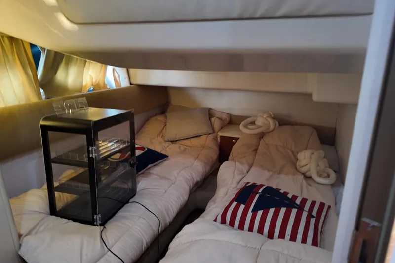  Yacht Photos Pics Cozy cabin interior of 2007 Cranchi Atlantique 40 yacht with twin beds and nautical decor.
