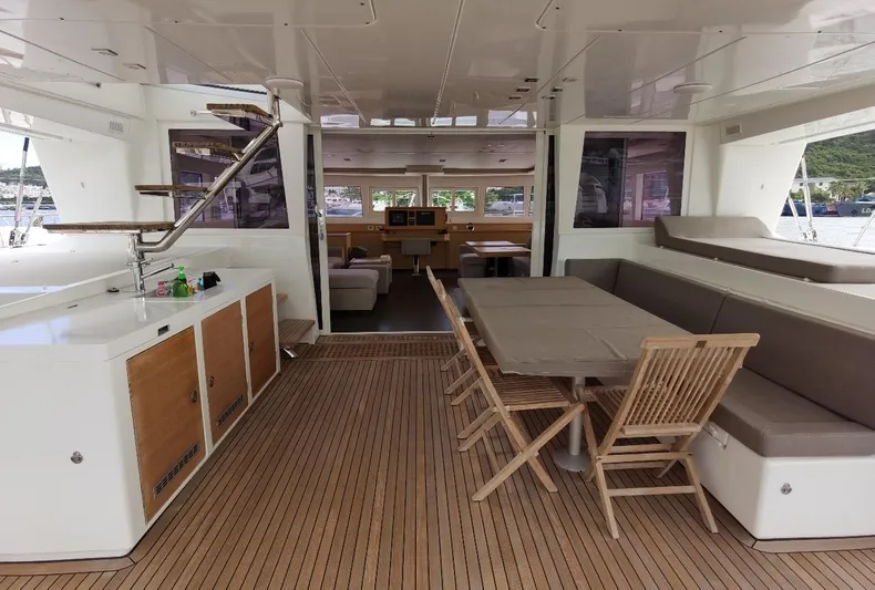 Er Yue Hua Hao Yacht Photos Pics Spacious interior of 2014 Lagoon 620 yacht with wooden flooring and seating area.