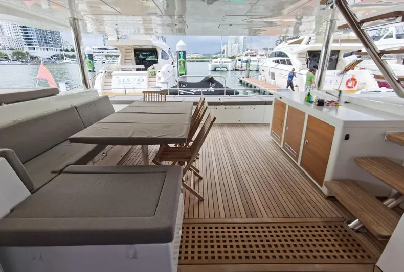 Er Yue Hua Hao Yacht Photos Pics Spacious deck of 2014 Lagoon 620 yacht with seating and dining area.