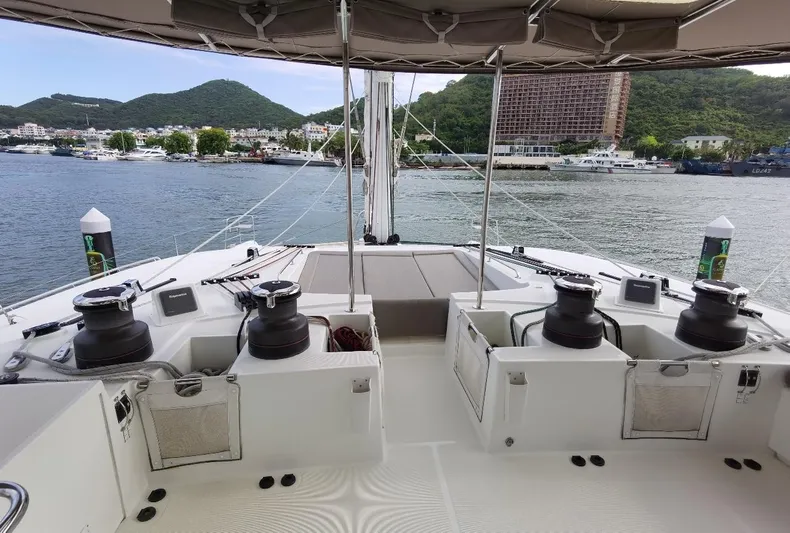 Er Yue Hua Hao Yacht Photos Pics Lagoon 620 yacht deck, 2014 model, overlooking a scenic harbor with hills in the background.