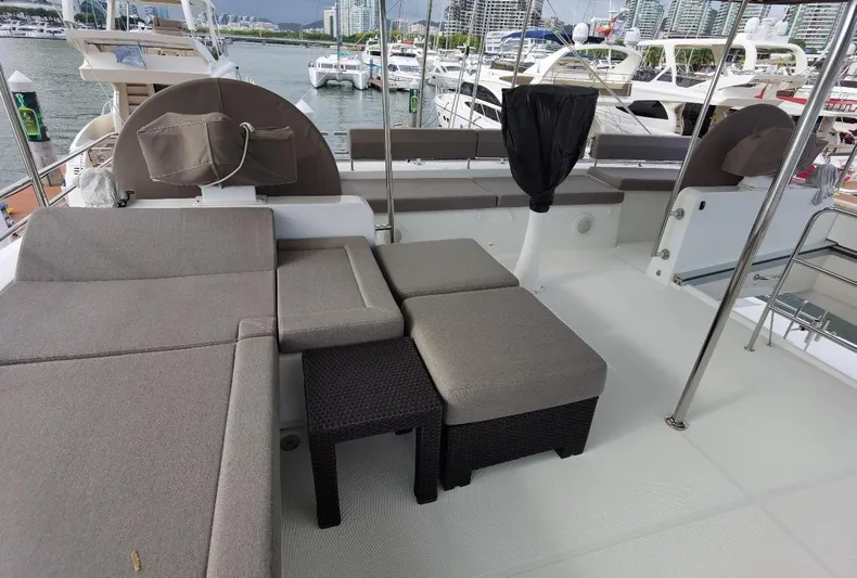 Er Yue Hua Hao Yacht Photos Pics Luxurious Lagoon 620 yacht deck with comfortable seating, docked at a marina, 2014 model.