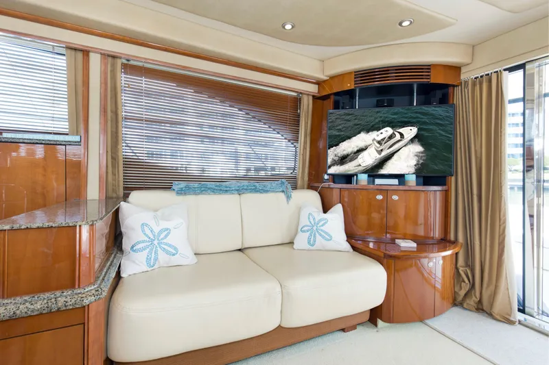 Reel Destiny Yacht Photos Pics Luxurious interior of 2007 Sea Ray 52 Sedan Bridge yacht with plush seating and TV.