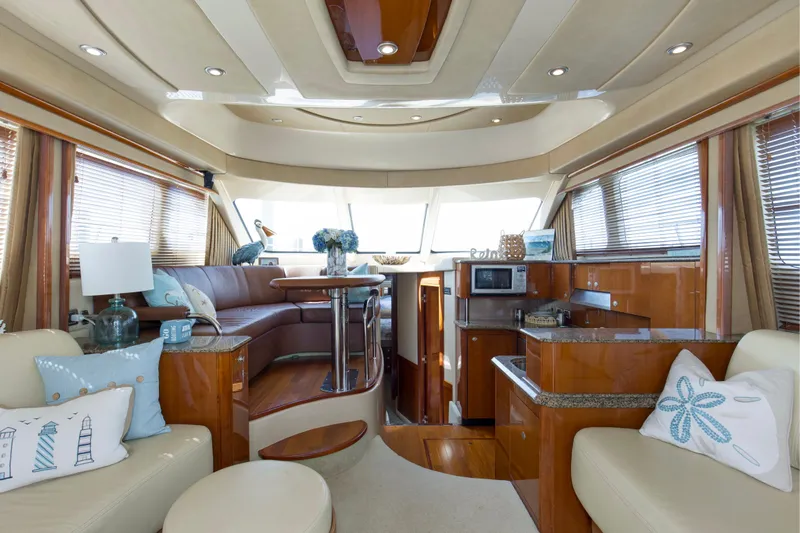 Reel Destiny Yacht Photos Pics Luxurious interior of 2007 Sea Ray 52 Sedan Bridge yacht with elegant seating and decor.
