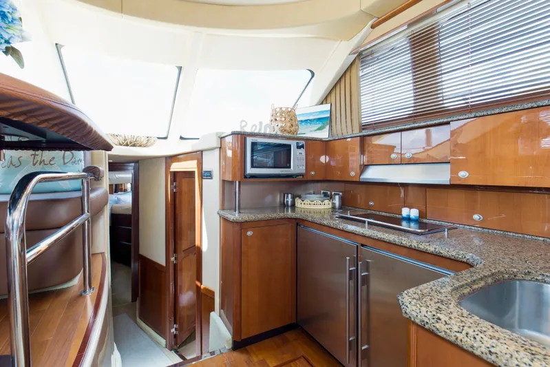 Reel Destiny Yacht Photos Pics Luxurious 2007 Sea Ray 52 Sedan Bridge yacht interior with modern kitchen and wood finishes.
