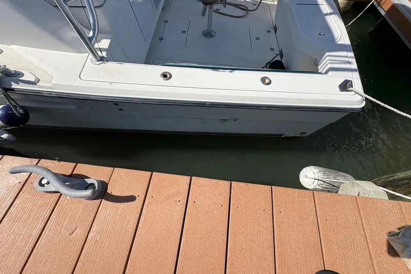 Free 2 Go Yacht Photos Pics 2006 Rampage 38 Express boat docked at a wooden pier.