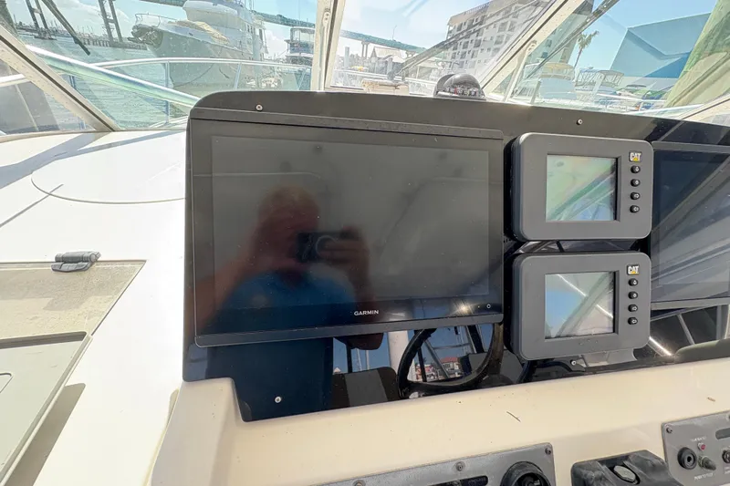 Free 2 Go Yacht Photos Pics Control panel of a 2006 Rampage 38 Express boat with Garmin and CAT displays.