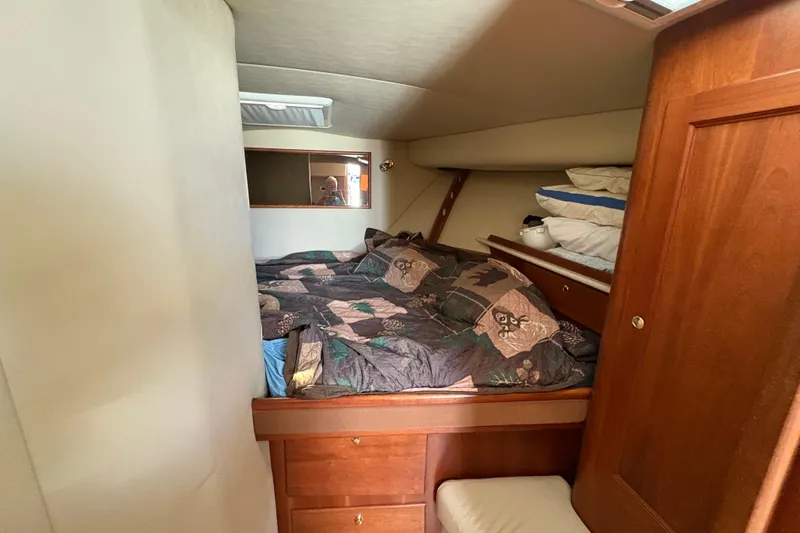 Free 2 Go Yacht Photos Pics Cozy cabin interior of 2006 Rampage 38 Express with bed and wooden storage.