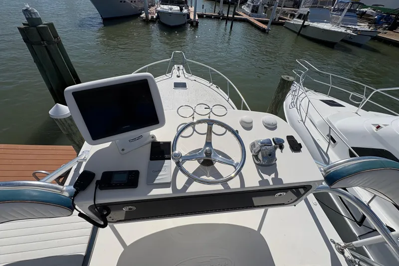 Free 2 Go Yacht Photos Pics Helm of 2006 Rampage 38 Express boat with navigation equipment and steering wheel.