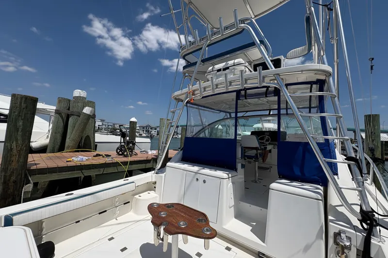 Free 2 Go Yacht Photos Pics 2006 Rampage 38 Express boat docked, featuring spacious deck and fishing equipment.