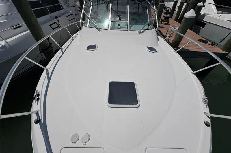 Free 2 Go Yacht Photos Pics 2006 Rampage 38 Express boat deck with railing, docked at marina.