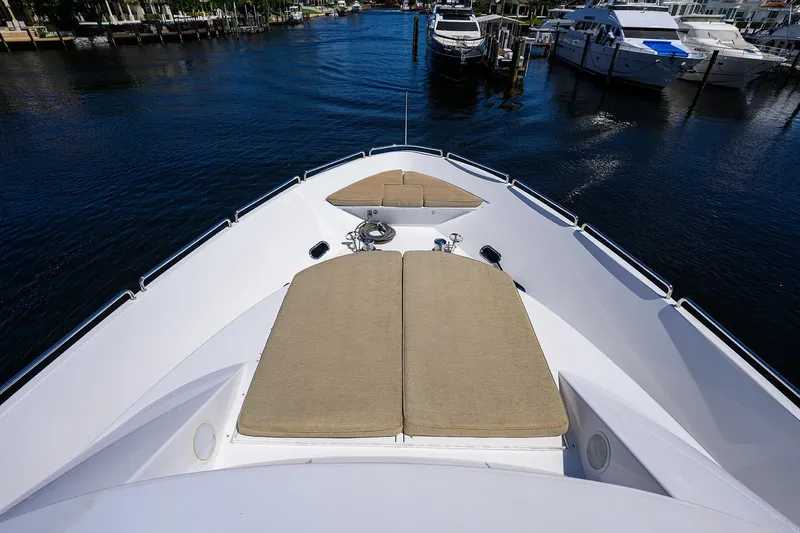 Remy Roo Yacht Photos Pics Bow view of 2014 Westport 112 yacht with sun pads, docked in marina.