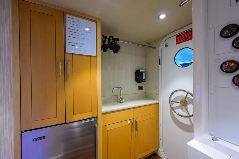 Remy Roo Yacht Photos Pics Compact yacht interior with wooden cabinets, sink, and porthole door on Westport 112, 2014 model.