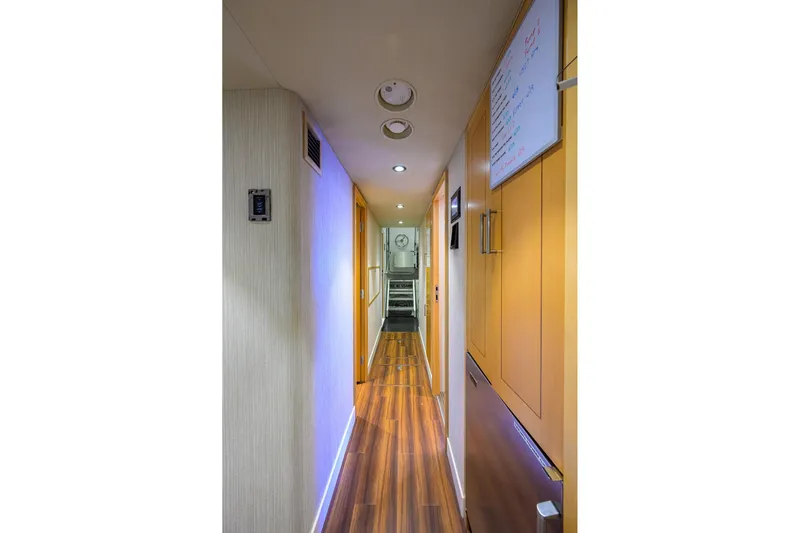 Remy Roo Yacht Photos Pics Narrow hallway inside 2014 Westport 112 yacht with wooden flooring and modern lighting.
