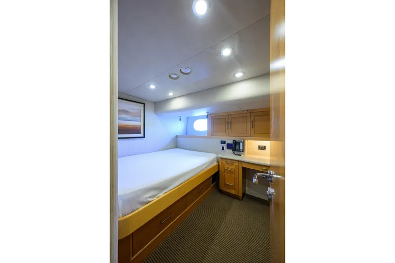 Remy Roo Yacht Photos Pics Luxurious cabin interior of 2014 Westport 112 yacht, featuring cozy bed and modern amenities.