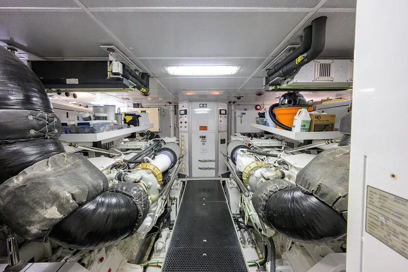 Remy Roo Yacht Photos Pics Engine room of a 2014 Westport 112 yacht, featuring dual engines and organized storage.