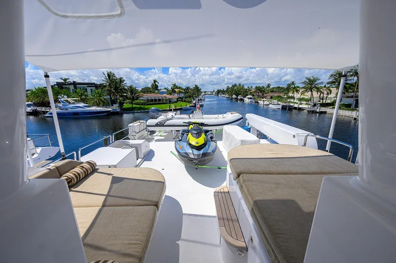 Remy Roo Yacht Photos Pics Luxurious 2014 Westport 112 yacht deck with jet ski, overlooking scenic waterfront.