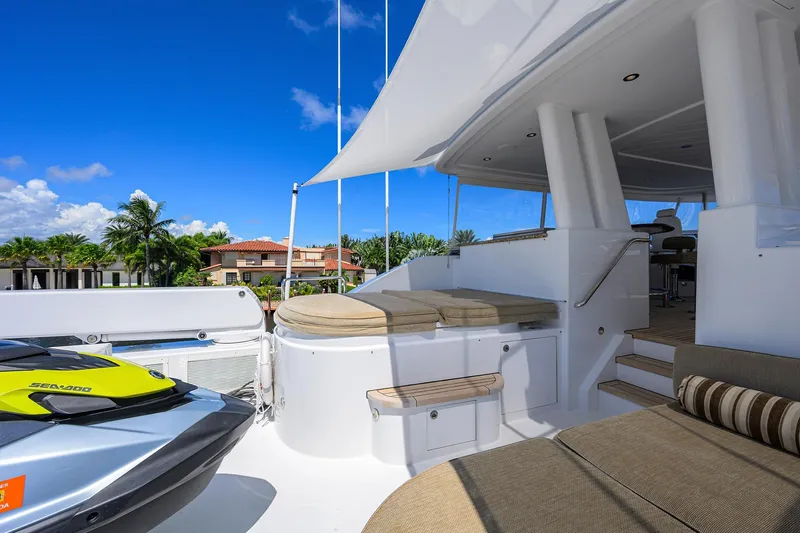 Remy Roo Yacht Photos Pics Luxurious 2014 Westport 112 yacht deck with seating, jet ski, and tropical backdrop.