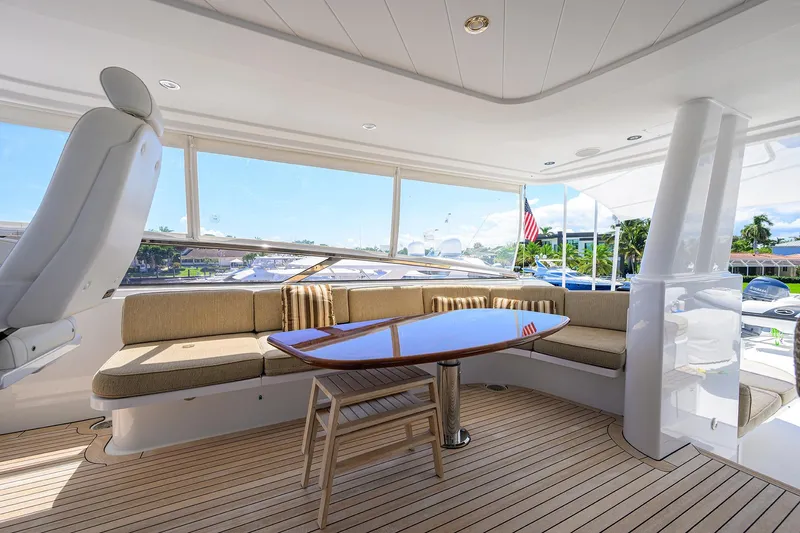 Remy Roo Yacht Photos Pics Luxurious 2014 Westport 112 yacht interior with elegant seating and polished wooden table.