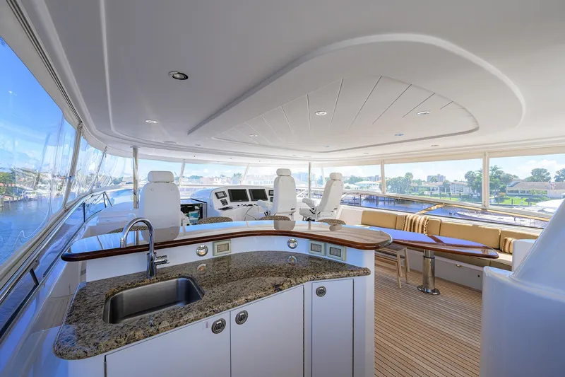 Remy Roo Yacht Photos Pics Luxurious 2014 Westport 112 yacht interior with modern helm, seating, and kitchenette.