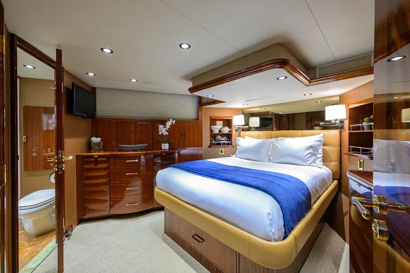 Remy Roo Yacht Photos Pics Luxurious bedroom interior on 2014 Westport 112 yacht, featuring elegant wood finishes and modern amenities.