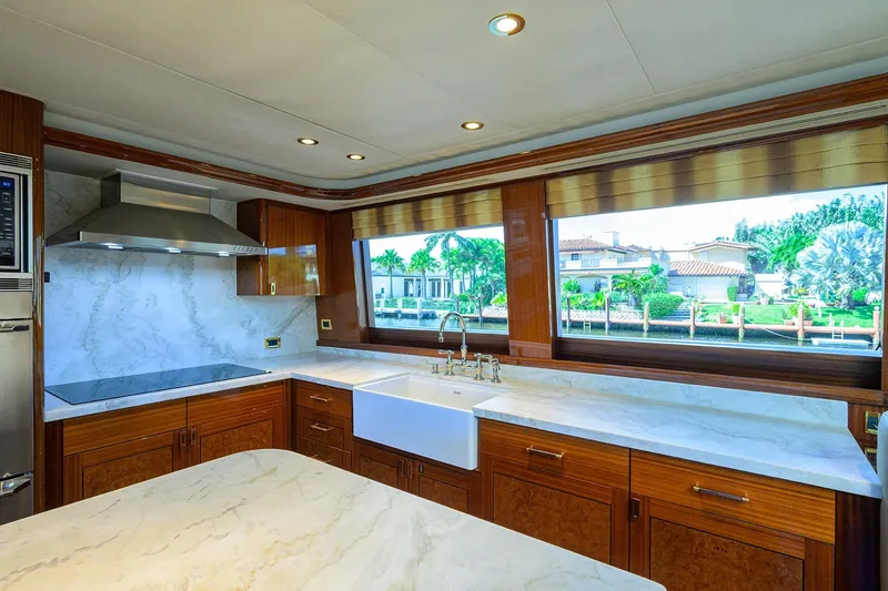 Remy Roo Yacht Photos Pics Luxurious kitchen interior on 2014 Westport 112 yacht with marble countertops and large windows.