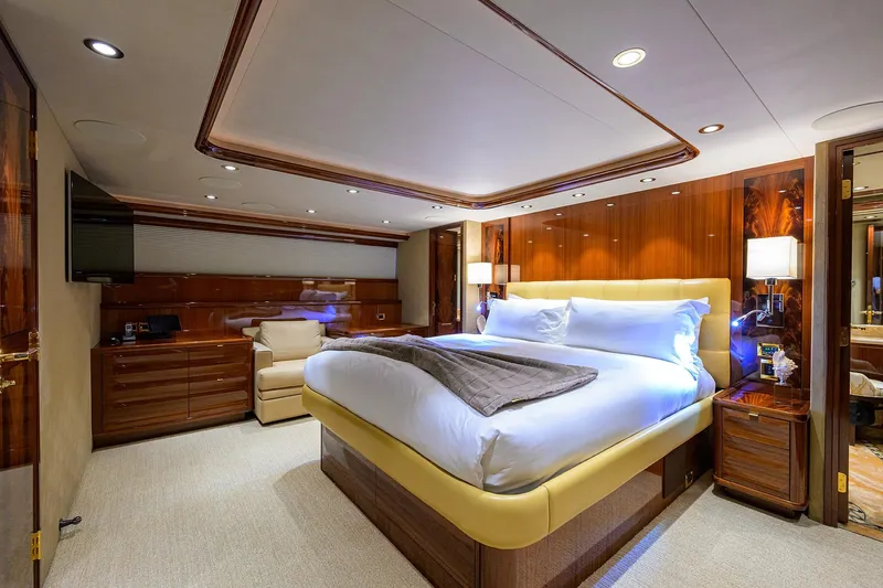Remy Roo Yacht Photos Pics Luxurious bedroom interior on 2014 Westport 112 yacht, featuring elegant wood finishes and modern amenities.