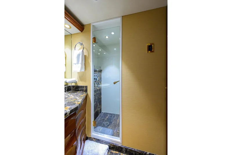 Remy Roo Yacht Photos Pics Luxurious bathroom in 2014 Westport 112 yacht with marble countertop and glass shower door.