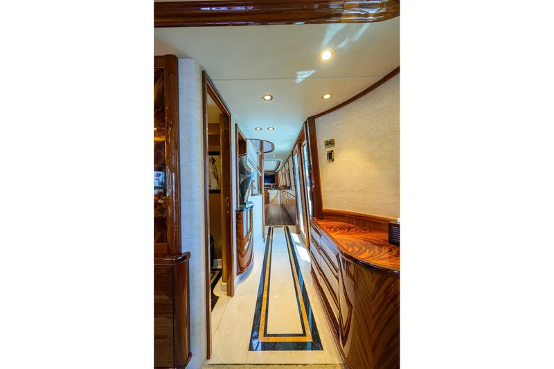 Remy Roo Yacht Photos Pics Luxurious interior hallway of a 2014 Westport 112 yacht, featuring elegant wood finishes.