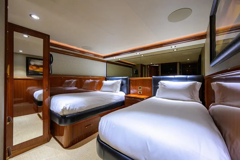 Remy Roo Yacht Photos Pics Luxurious twin bedroom on 2014 Westport 112 yacht, featuring elegant wood paneling and plush bedding.