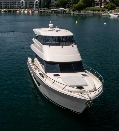 One More Yacht Photos Pics 2024 Maritimo M55 yacht cruising on a serene lake near a marina.