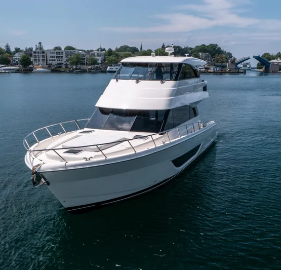 One More Yacht Photos Pics 2024 Maritimo M55 yacht cruising on a serene waterway with scenic background.