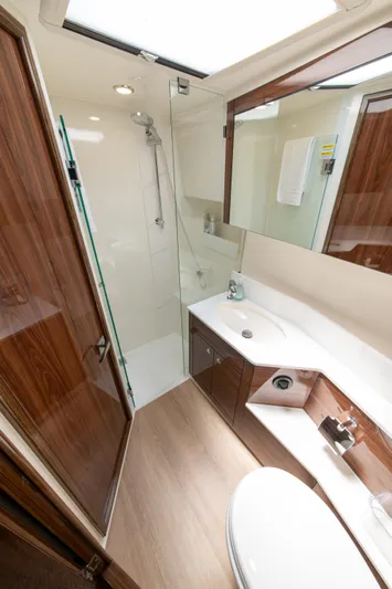 One More Yacht Photos Pics Luxurious bathroom in 2024 Maritimo M55 yacht with modern fixtures and wood accents.