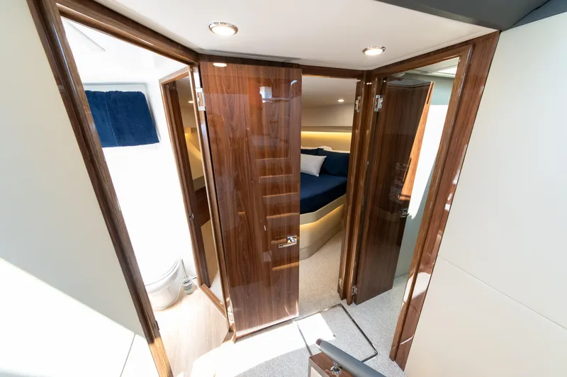 One More Yacht Photos Pics Luxurious interior of 2024 Maritimo M55 yacht with wooden doors and cozy bedroom.