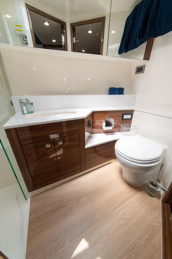 One More Yacht Photos Pics Luxurious bathroom in 2024 Maritimo M55 yacht with modern fixtures and wooden cabinetry.