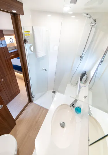 One More Yacht Photos Pics Luxurious bathroom in 2024 Maritimo M55 yacht with modern fixtures and glass shower.