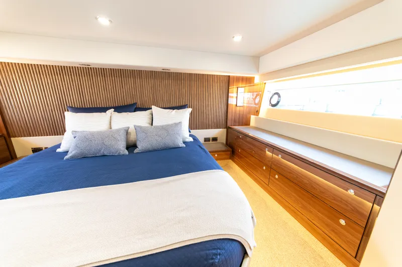 One More Yacht Photos Pics Luxurious bedroom interior of 2024 Maritimo M55 yacht with elegant wood paneling.