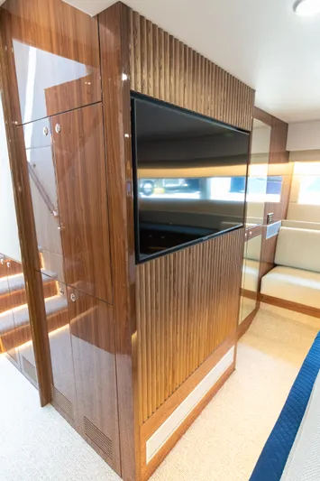 One More Yacht Photos Pics Luxurious interior of 2024 Maritimo M55 yacht with wood paneling and modern TV.